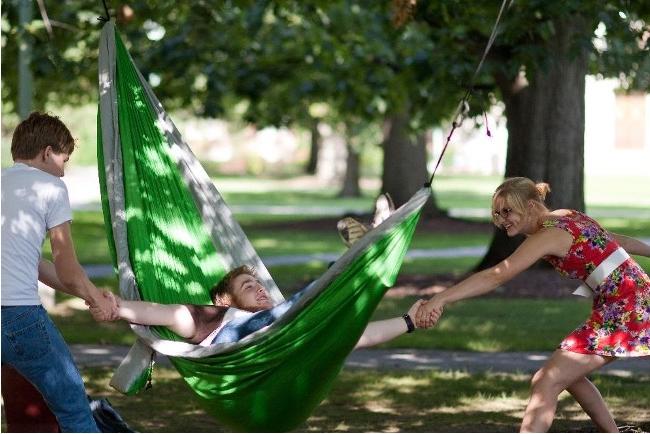 Three students hanging out on the quad.